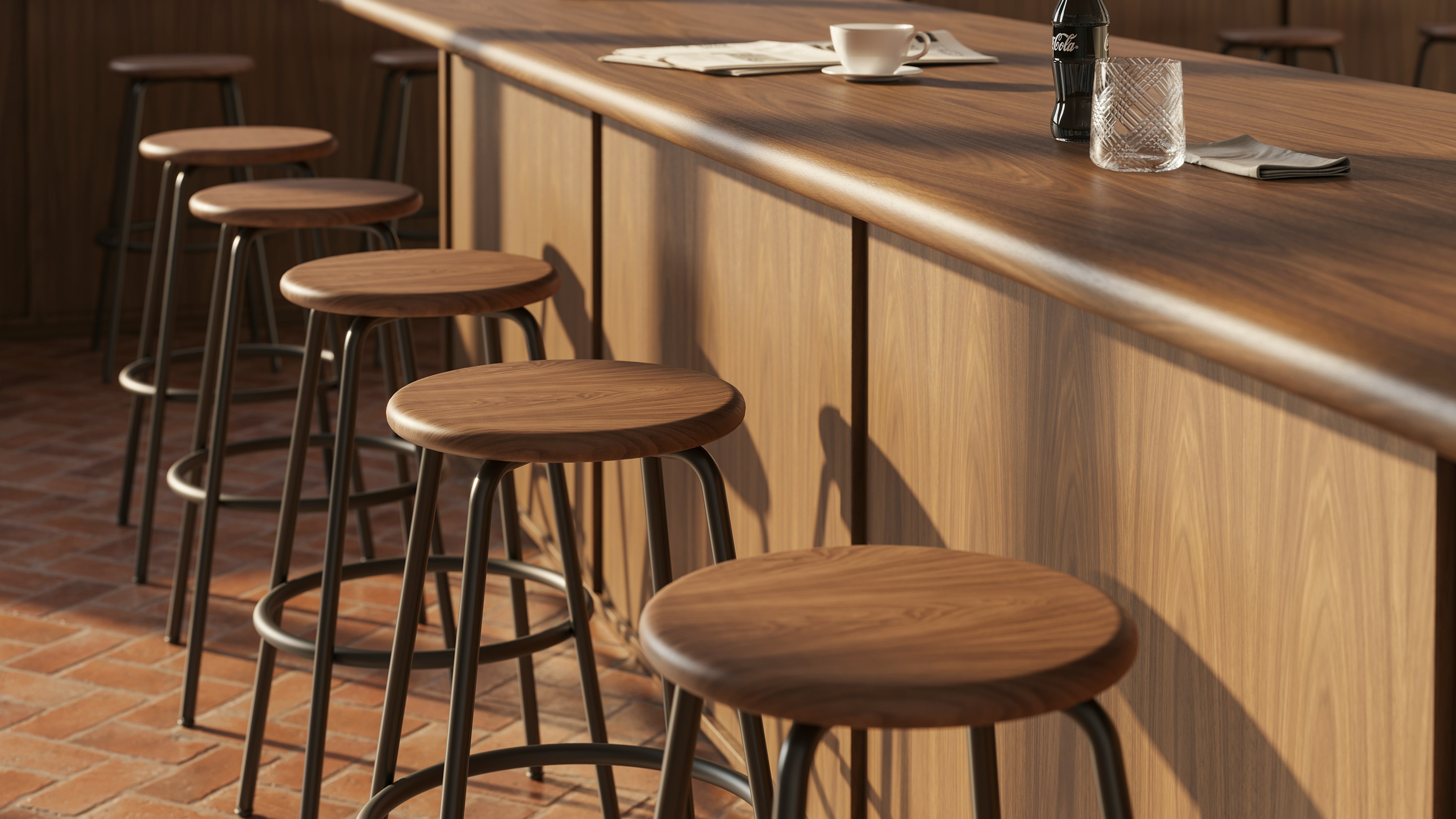 Row of Penny stools with walnut seats and powder-coated bases at a bar.