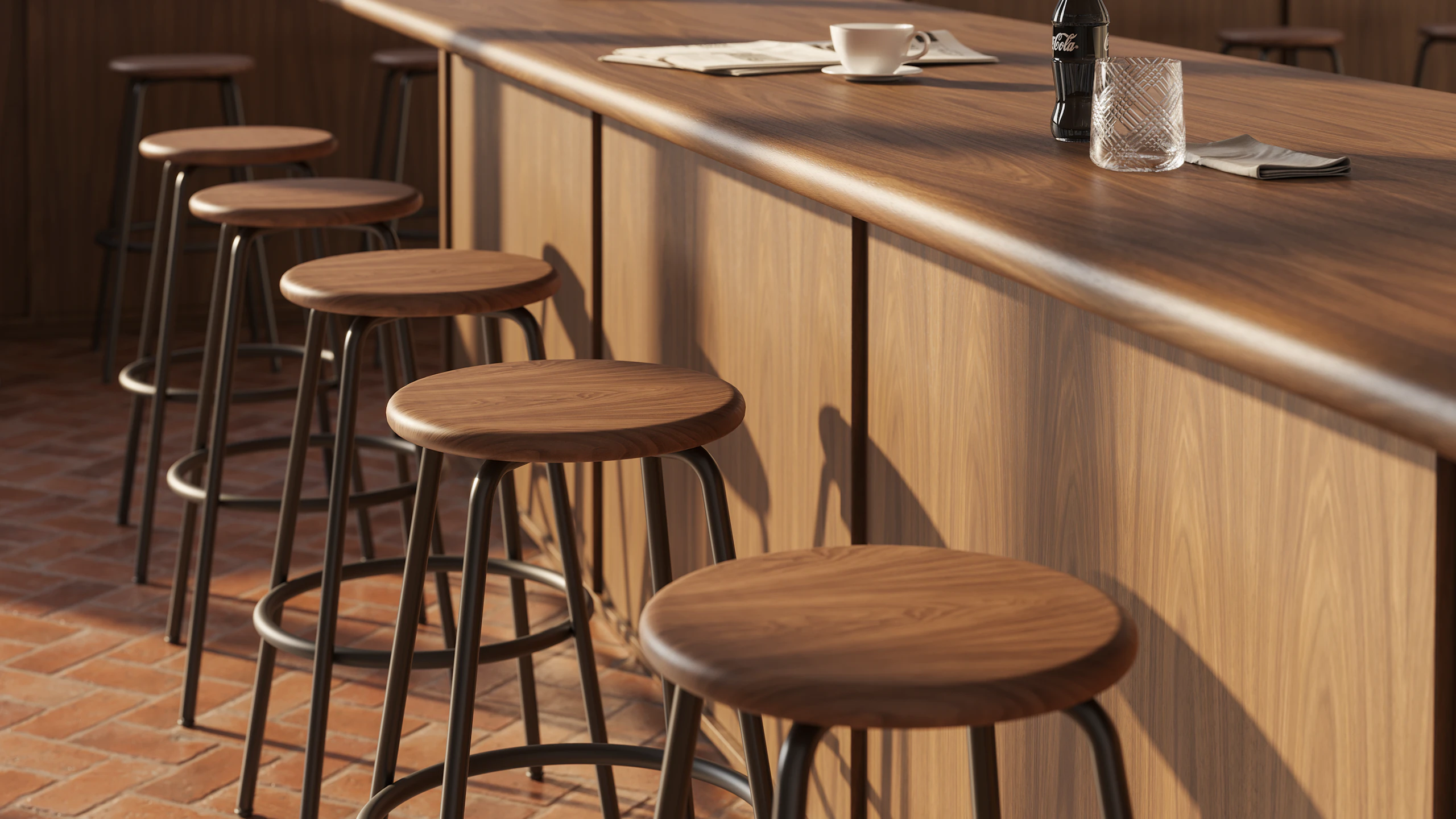 Row of Penny stools with walnut seats and powder-coated bases at a bar.