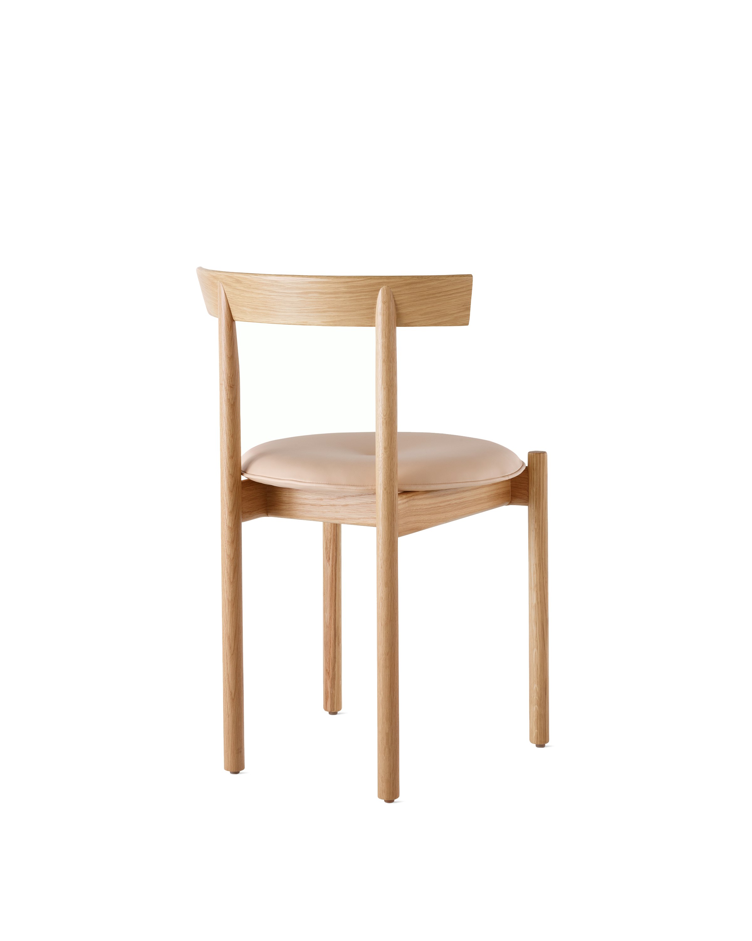 An oak Comma Chair with a seat pad, viewed from the back at an angle.