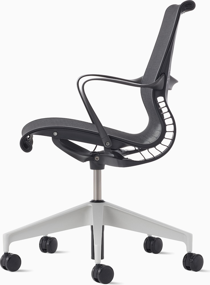 Side view of a Setu chair in dark grey with a silver alloy base.