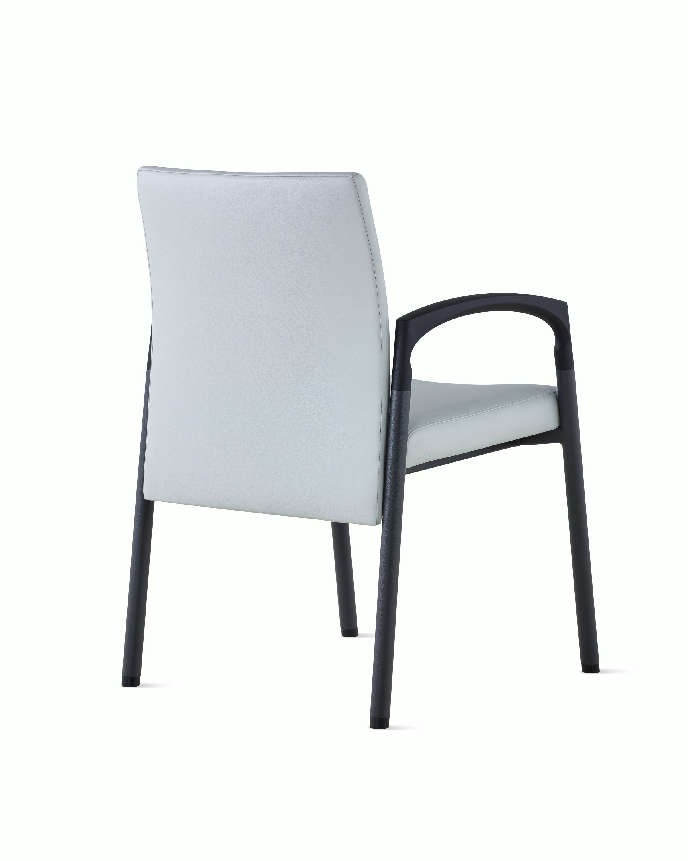 Three-quarter, back view of Valor Side Chair in a light gray upholstery on the back and seat and a black metal frame.