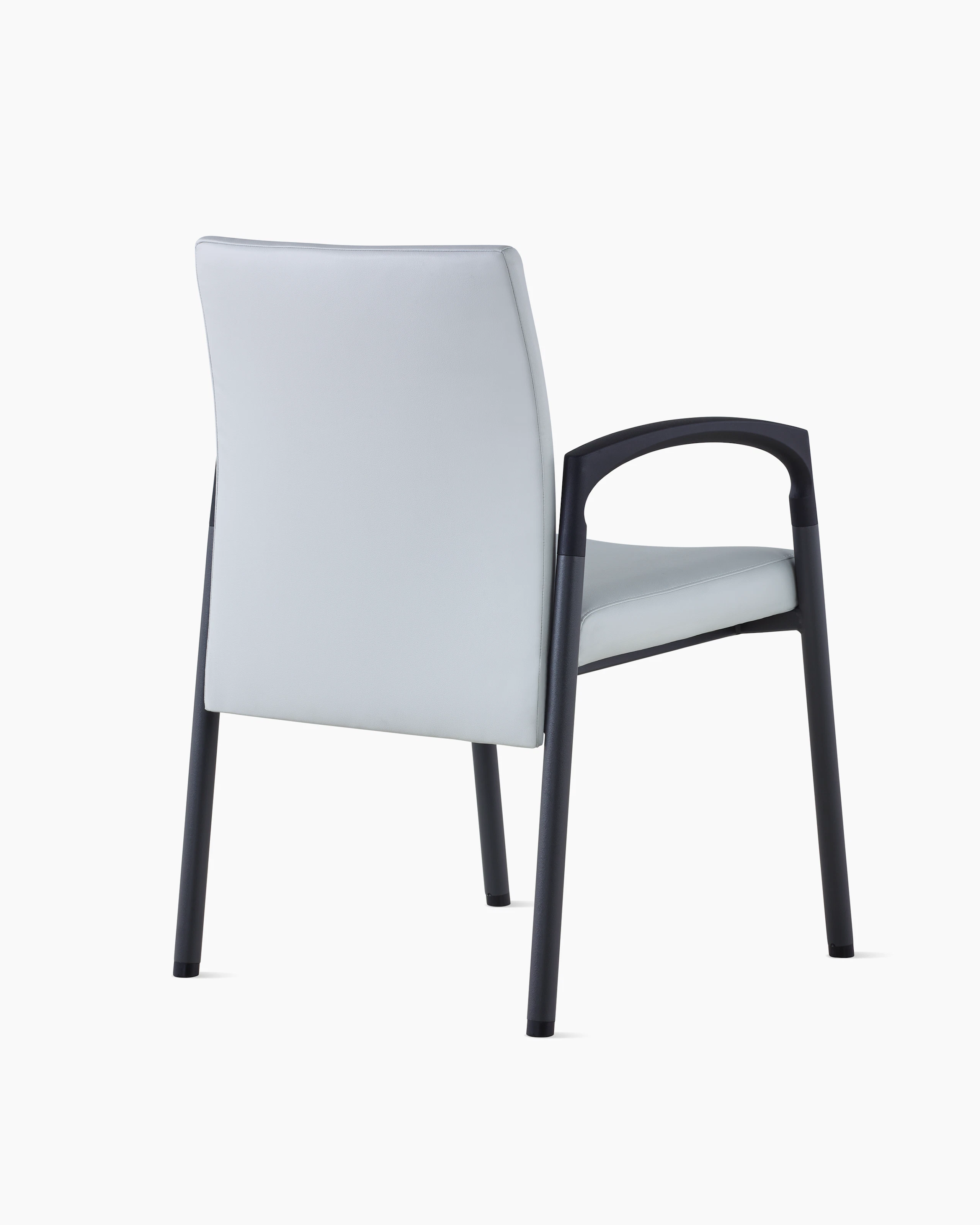 Three-quarter, back view of Valor Side Chair in a light gray upholstery on the back and seat and a black metal frame.