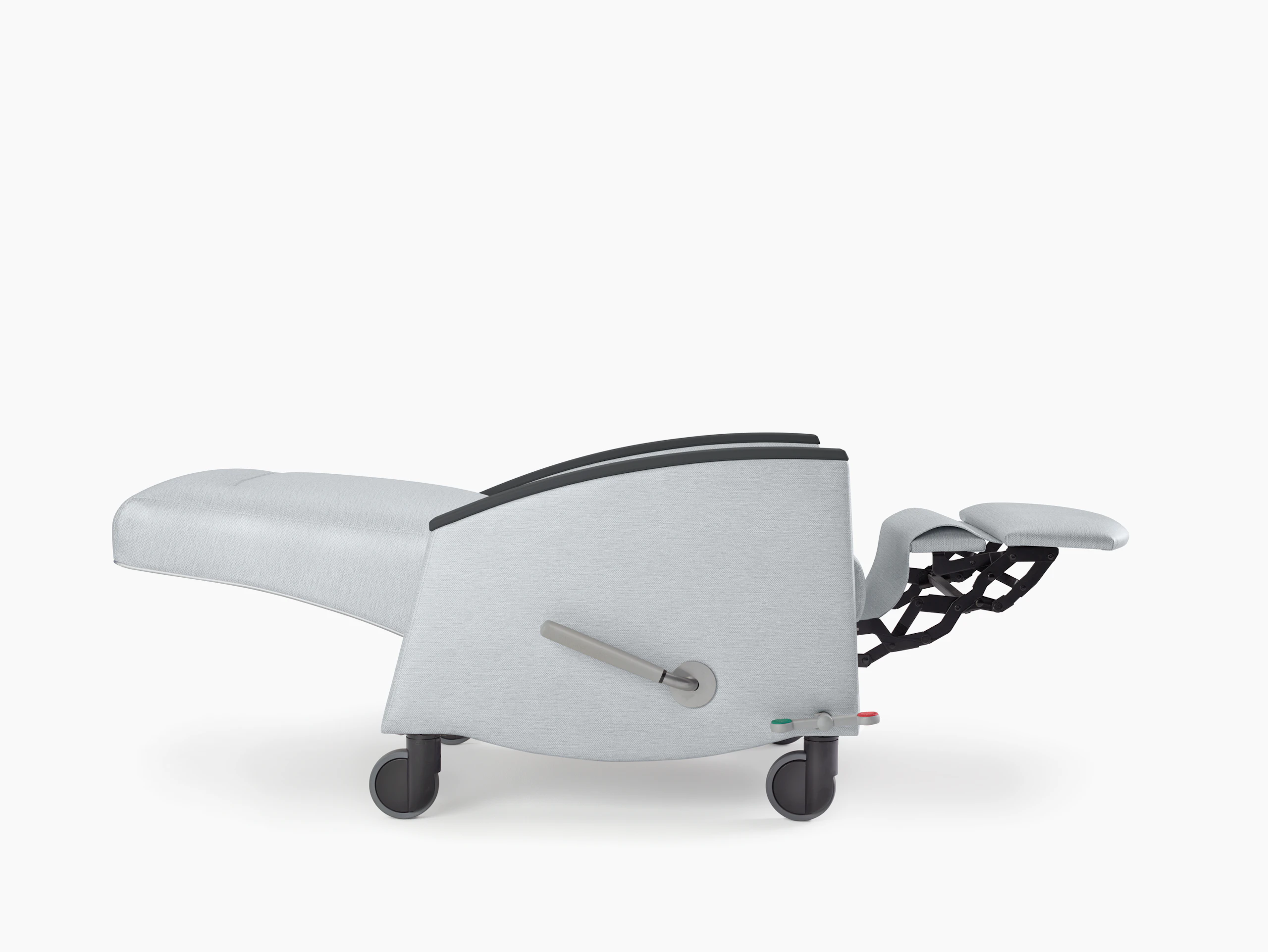 Nemschoff Sahara Recliner in a light gray upholstery and black arm caps and casters with the back and footrest fully extended, viewed from the side.