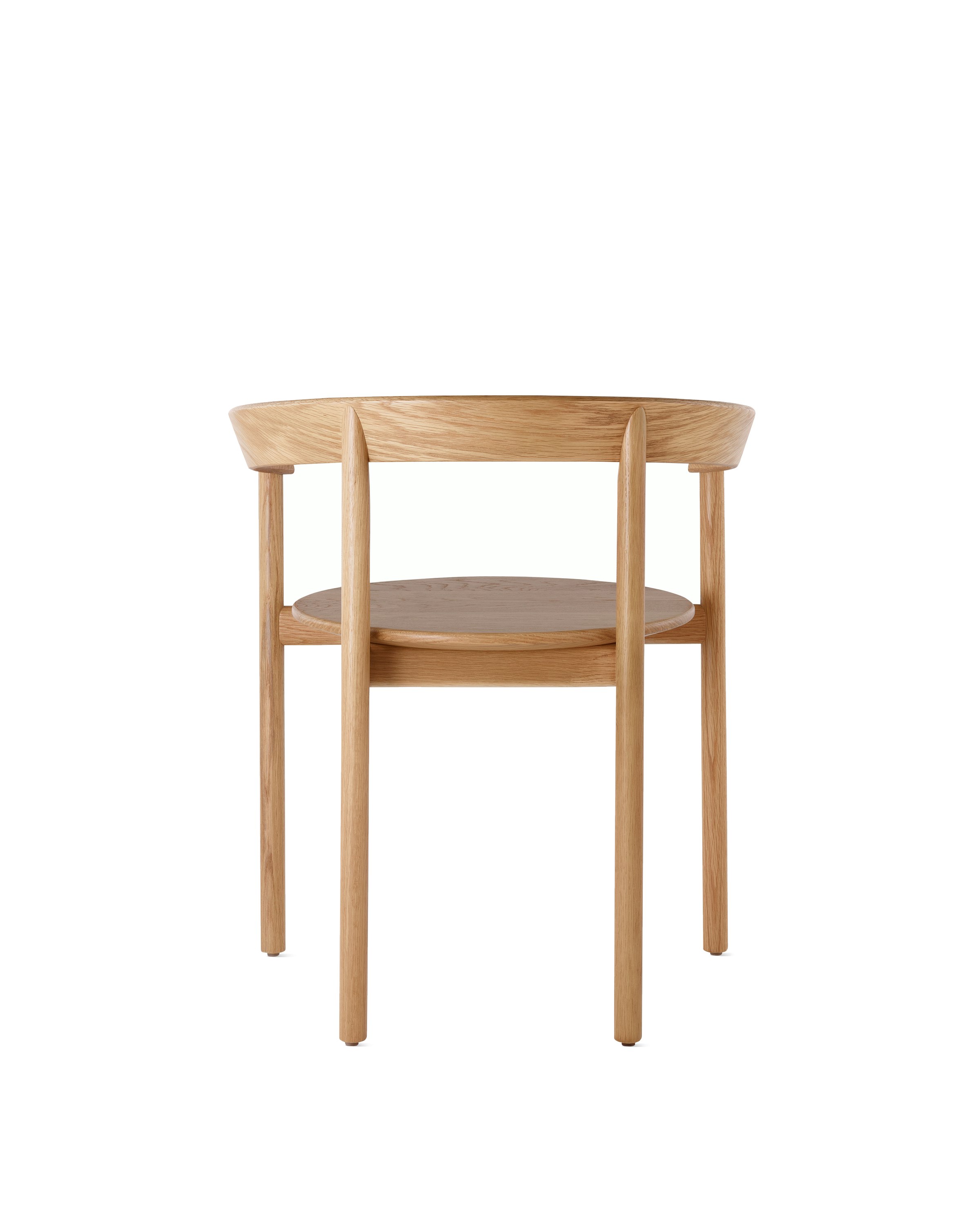 An oak Comma Chair with arms, viewed from the back.