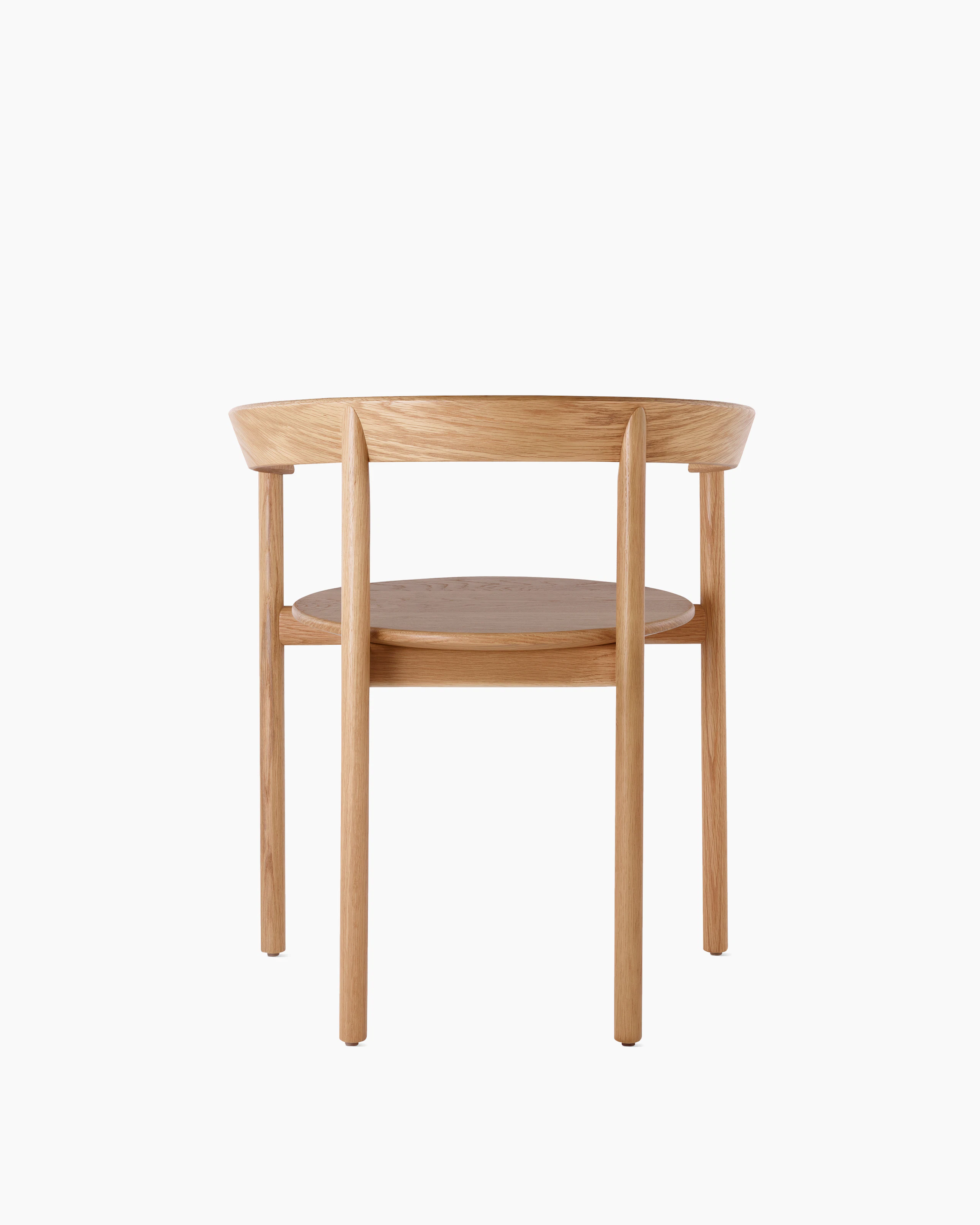An oak Comma Chair with arms, viewed from the back.