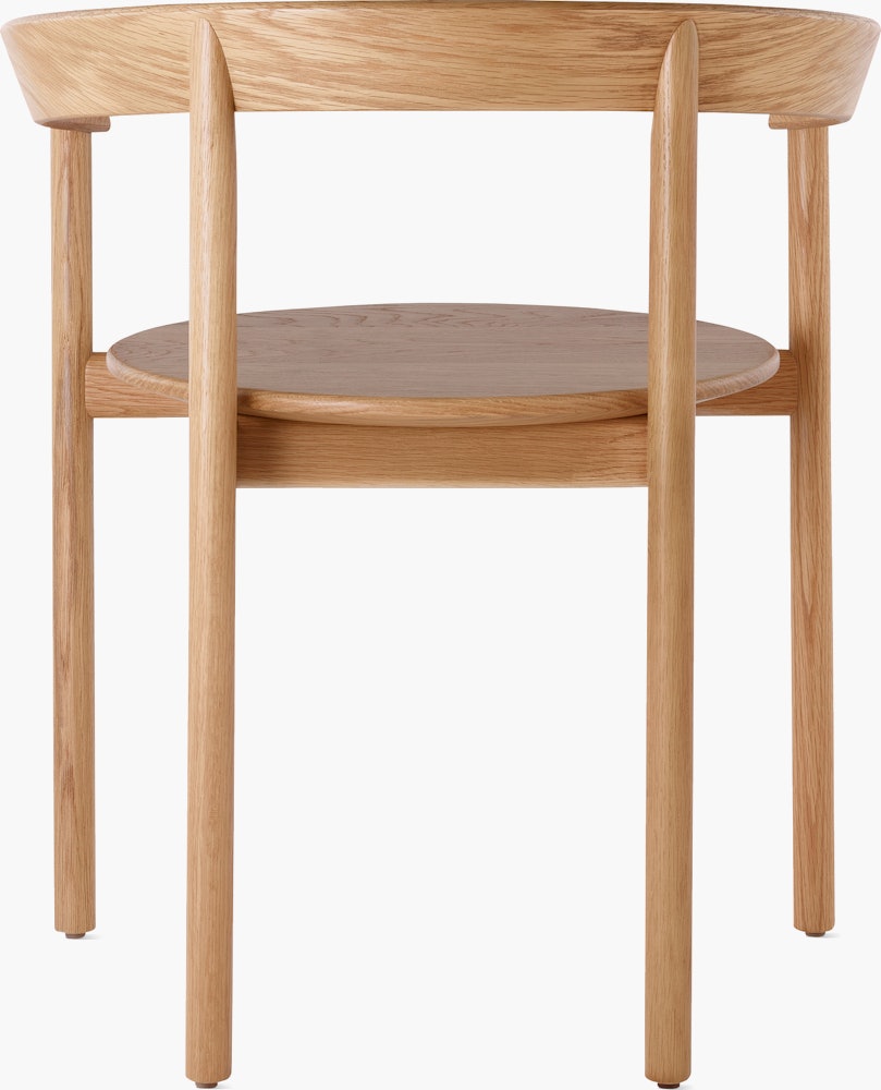 An oak Comma Chair with arms, viewed from the back.