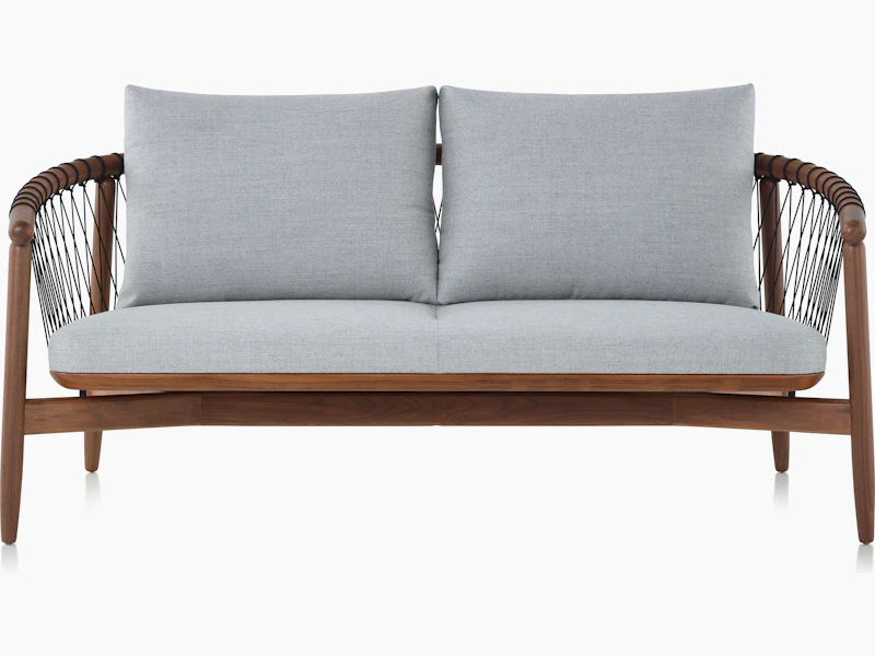 A Crosshatch Settee with a walnut frame, black cords, and light neutral fabric, viewed from the front.