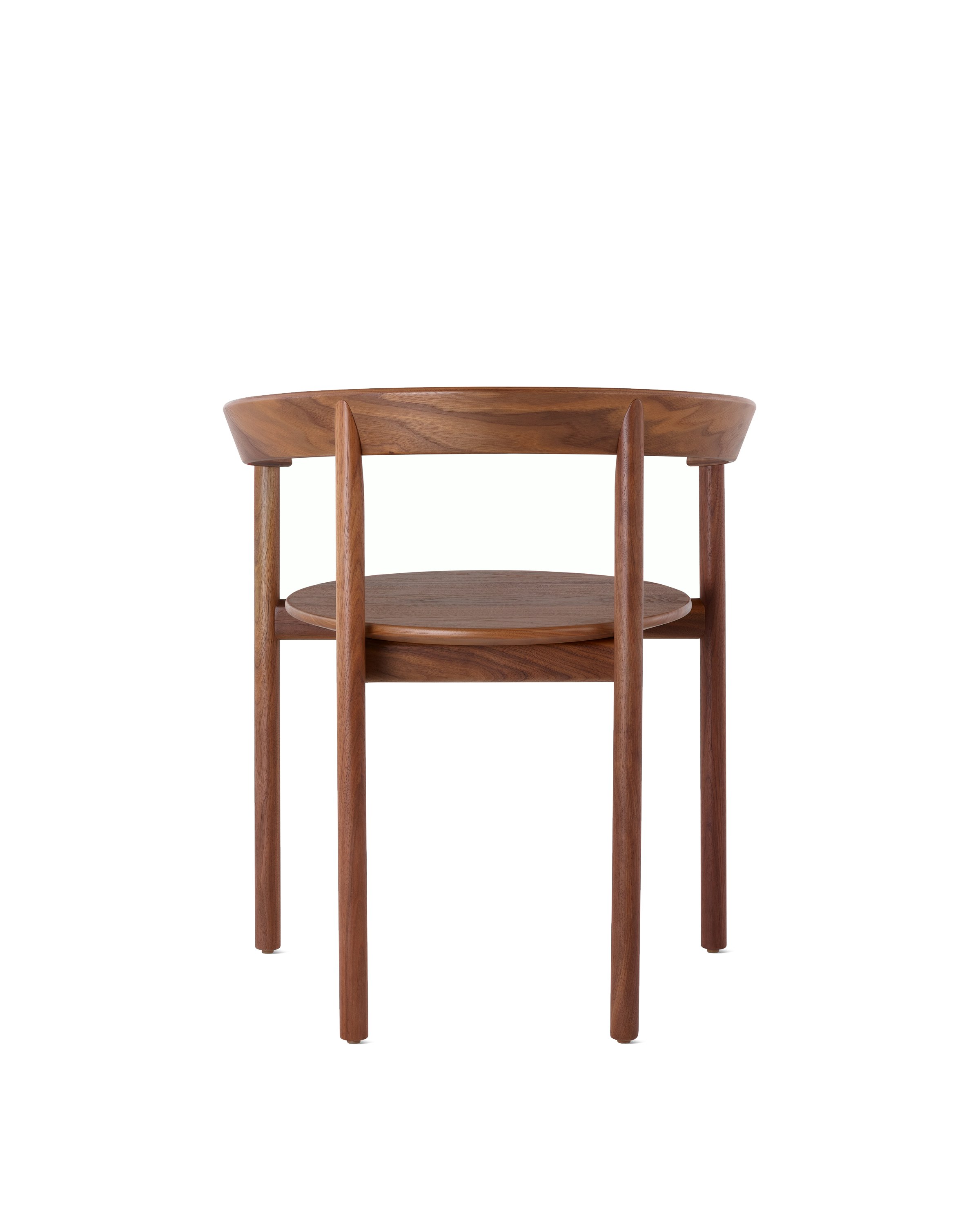 A walnut Comma Chair with arms, viewed from the back.