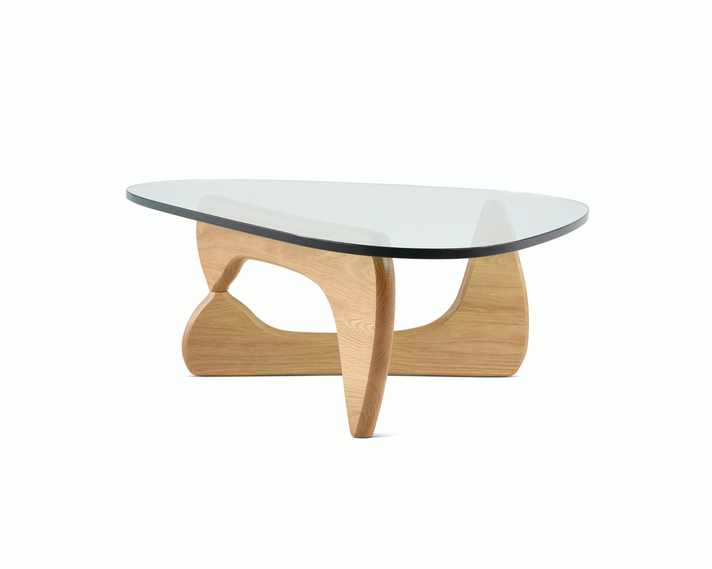 A Noguchi Table with light wood base and glass top.