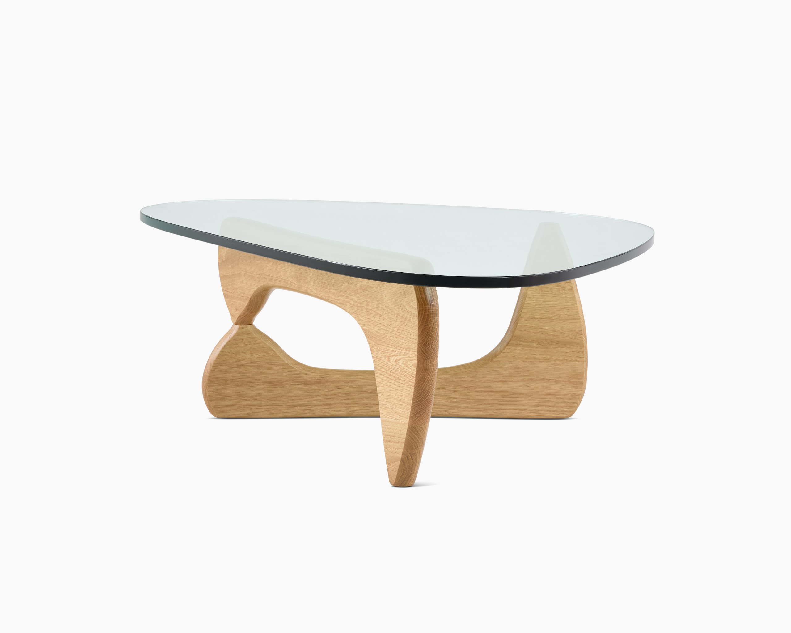 A Noguchi Table with light wood base and glass top.