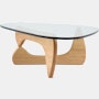 A Noguchi Table with light wood base and glass top.