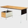 A Eames Desk with a wood and veneer birch top and drawer.