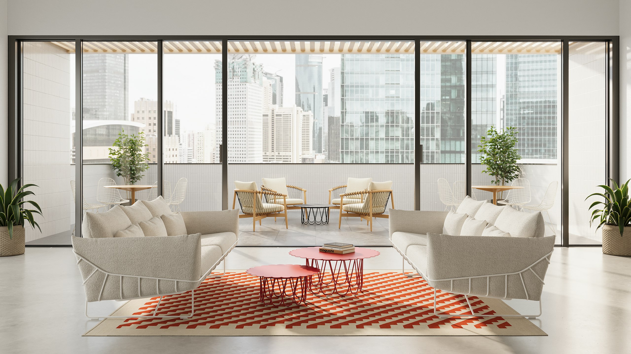 Indoor lounge area with a doorway to an outdoor lounge area featuring two white Wireframe Sofas in cream upholstery and red Girard Flower Tables. Outdoor setting features four Crosshatch Chairs and a black Girard Flower Table.