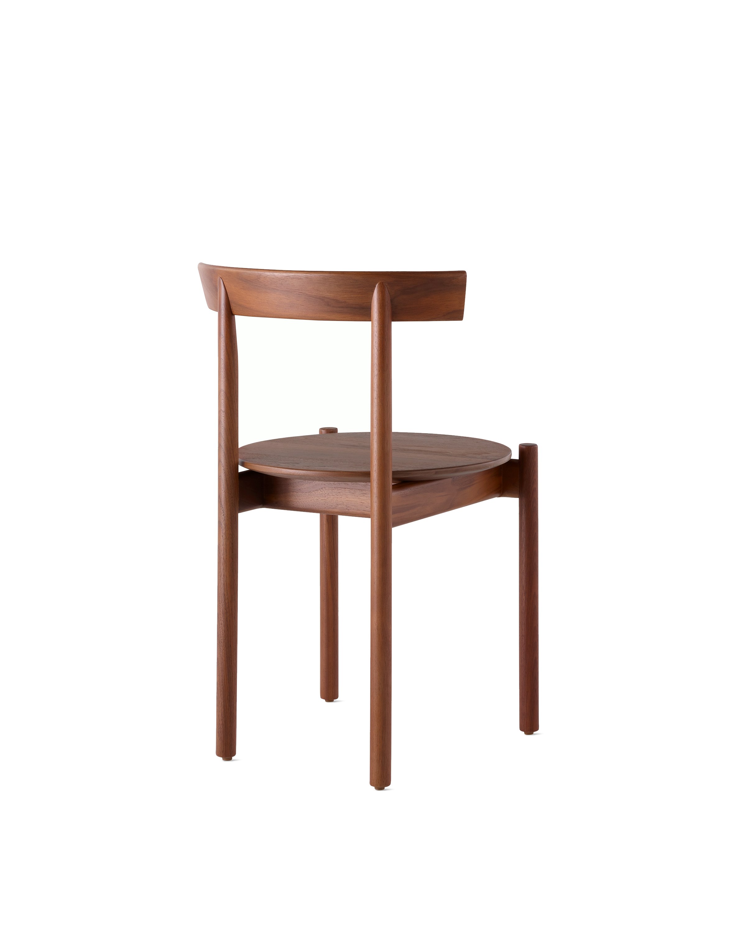 A walnut Comma Chair, viewed from the back at an angle.
