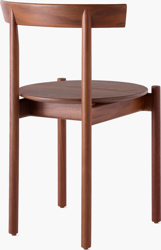 A walnut Comma Chair, viewed from the back at an angle.