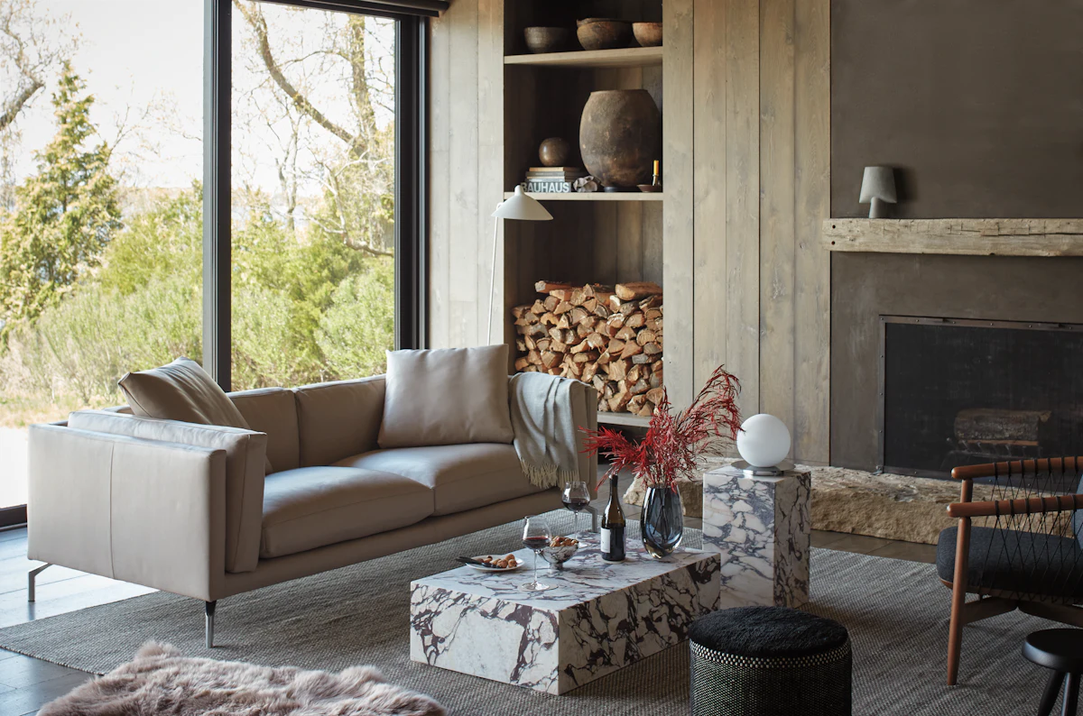 Living room with beige sofa, fireplace, and built-in shelves