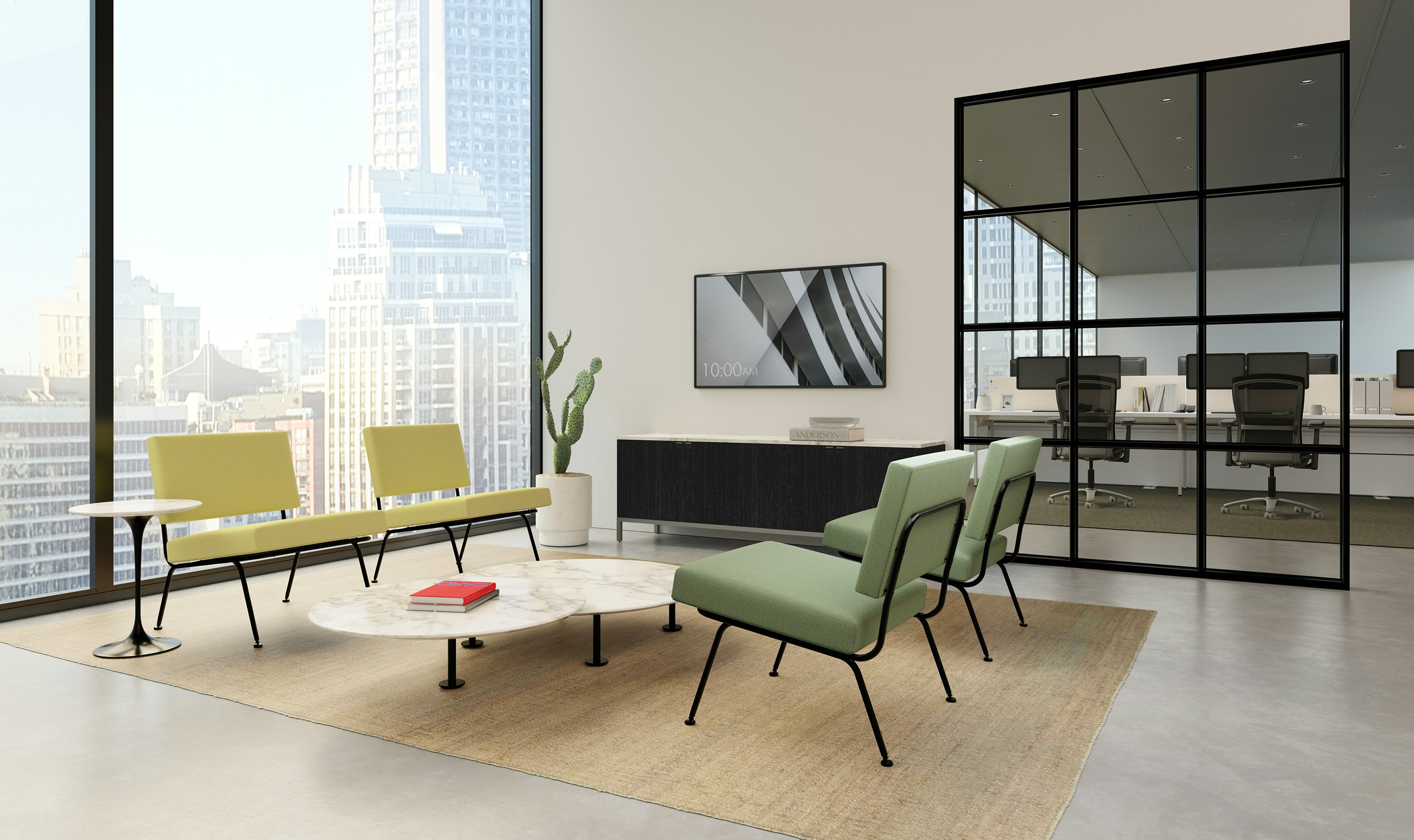 A bright reception area in an office with Florence Model 31 lounge chairs and Knoll Antenna workstations in the background.