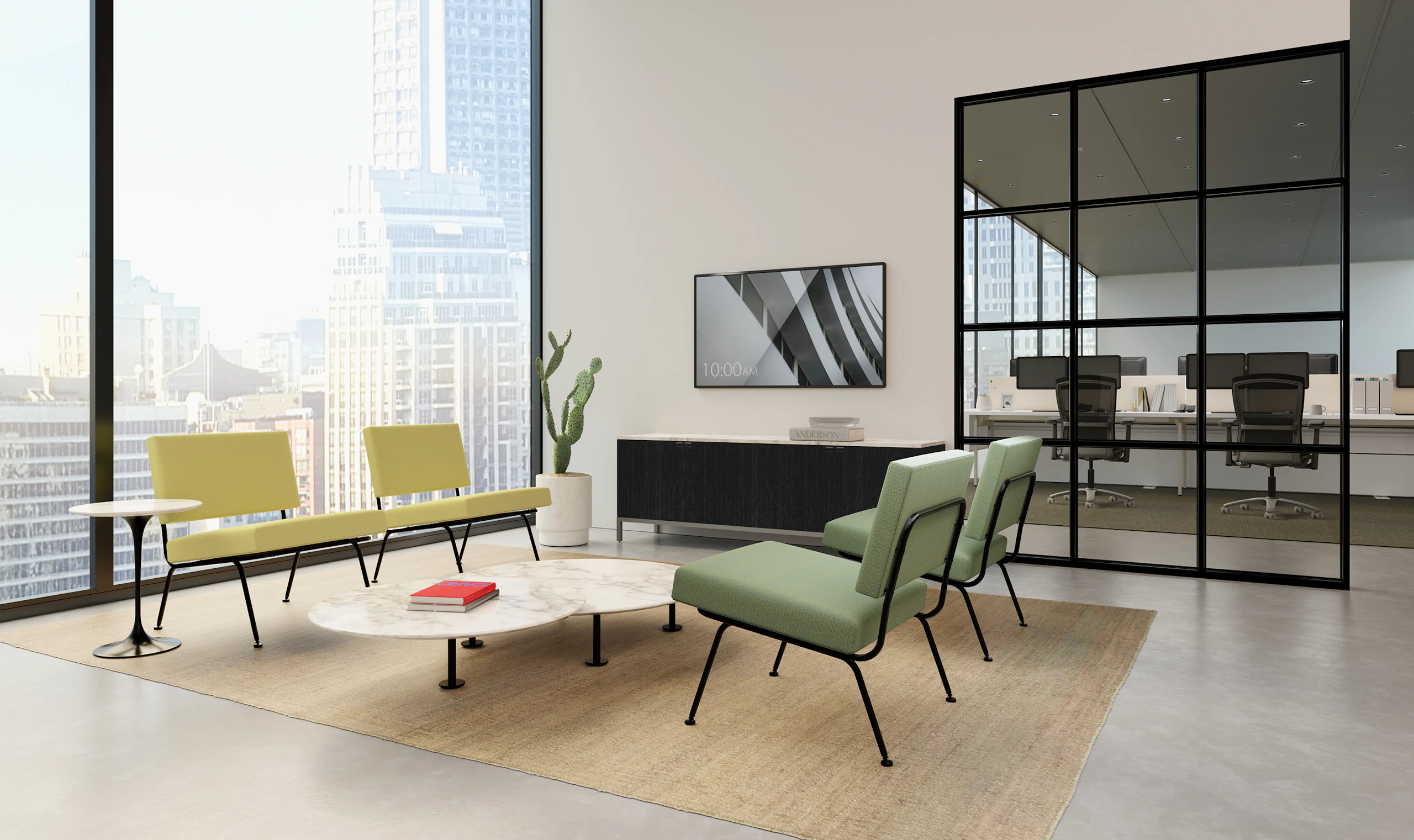 A bright reception area in an office with Florence Model 31 lounge chairs and Knoll Antenna workstations in the background.