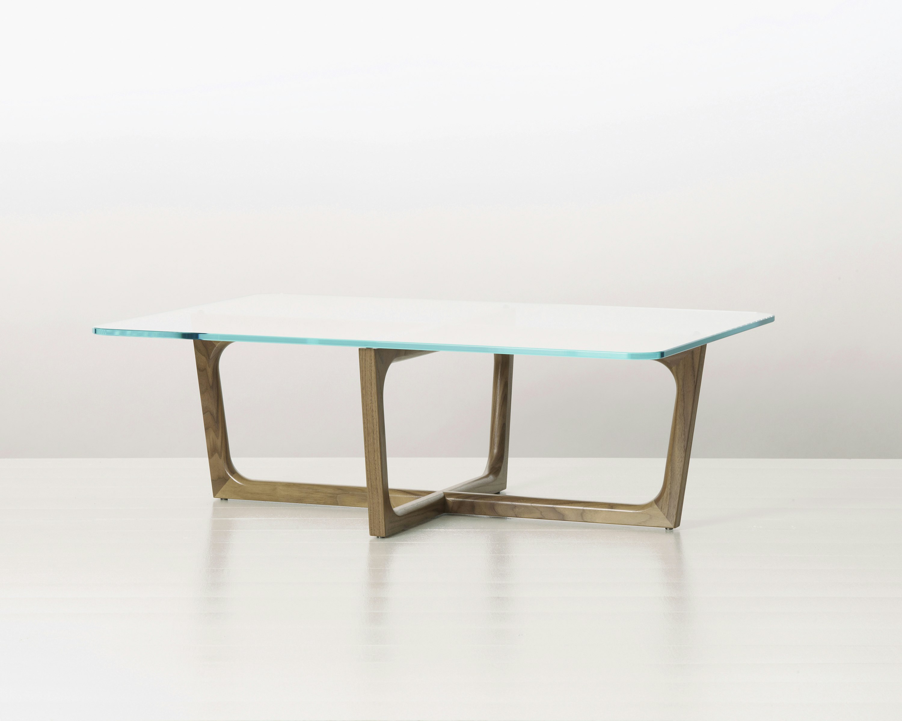 A rectangular Loophole coffee table with a walnut base.