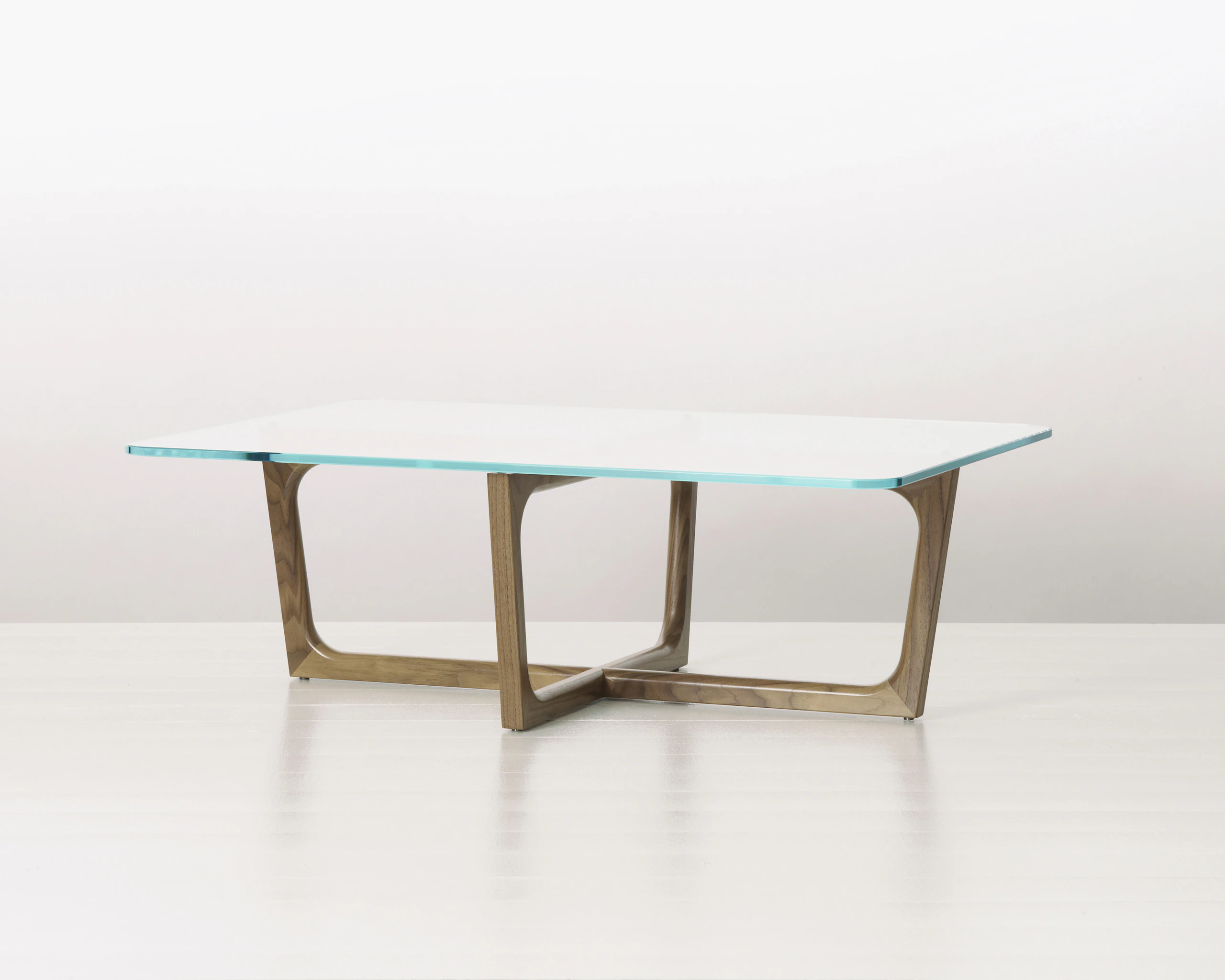 A rectangular Loophole coffee table with a walnut base.