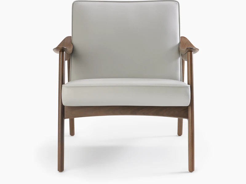 An Aspen Lounge Chair in a gray textile with walnut base and arms.
