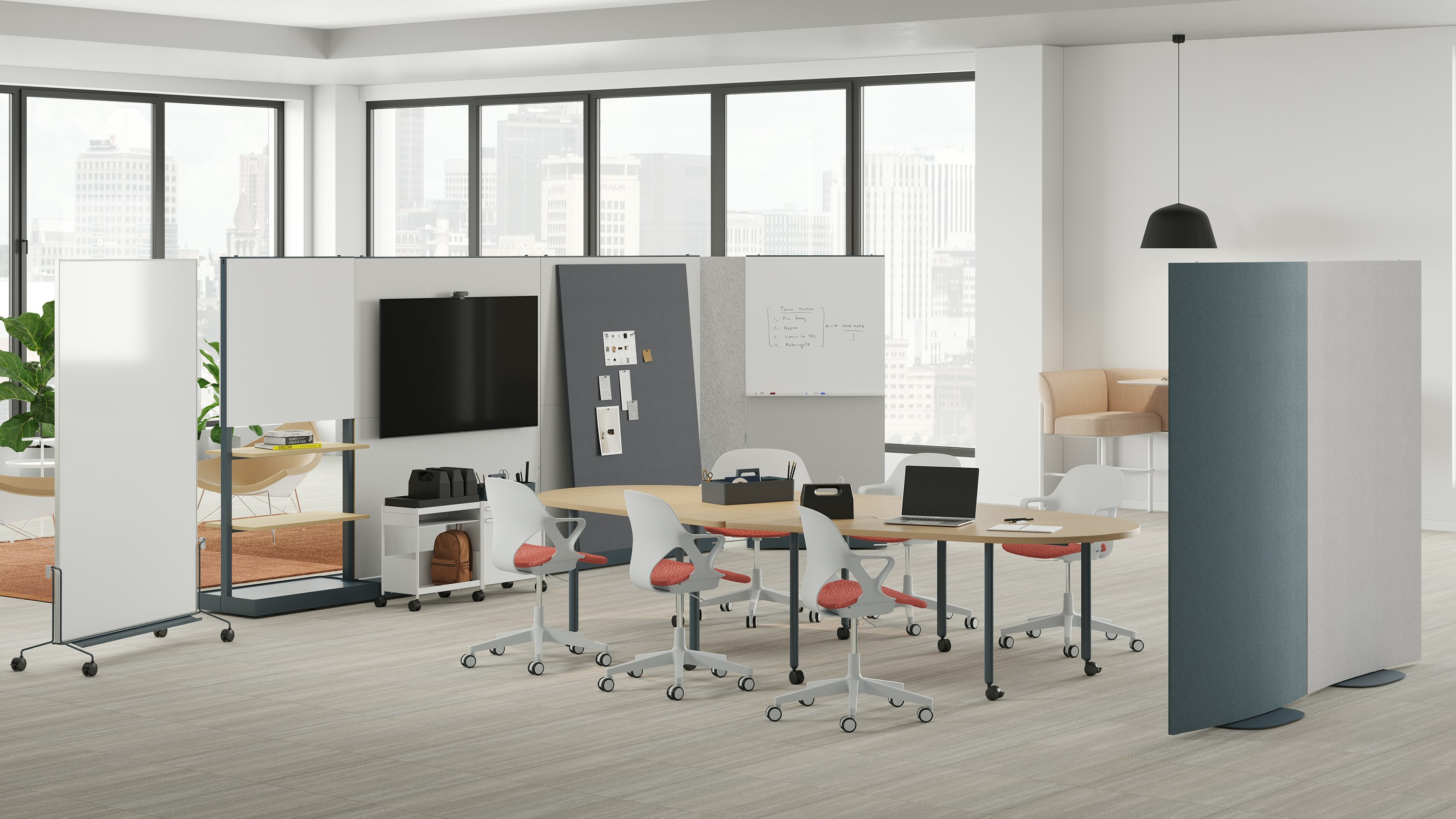 Open floor group meeting space with movable walls, tables, storage trolleys, easels and chairs.