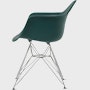 Side of evergreen plastic shell chair with wire base legs.