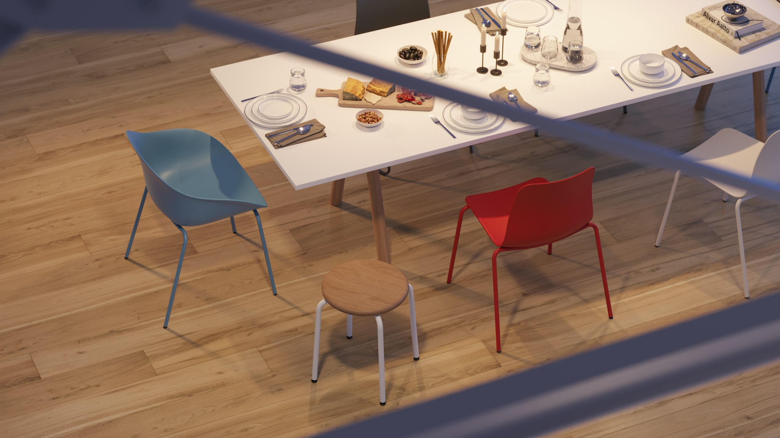 A birds eye view of a large Morse table with oak legs and a white MFMDF top, set up for dinner, with Ruby and Polly chairs around.