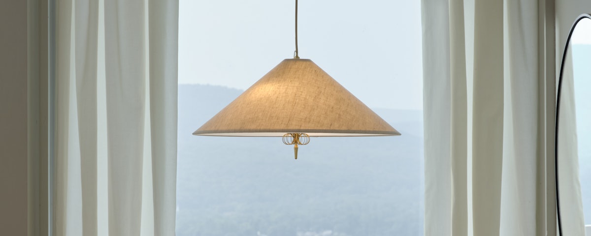 1967 Pendant suspended in front of a window