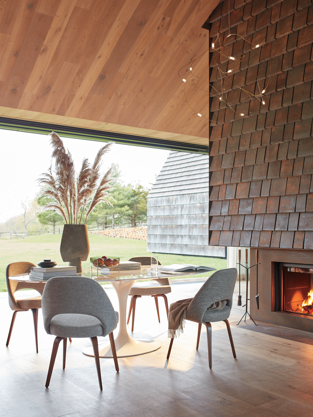 Saarinen Oval Dining with Saarinen Executive Chairs in outdoor/indoor dining room with pendant dimmed