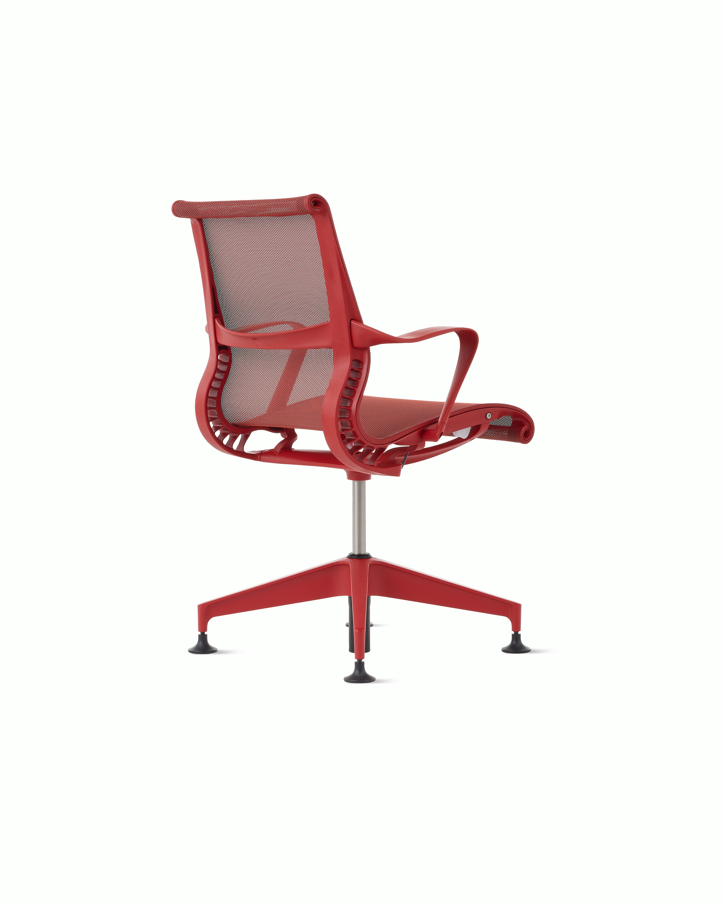 Rear angle view of a Setu side chair with fixed arms in red.