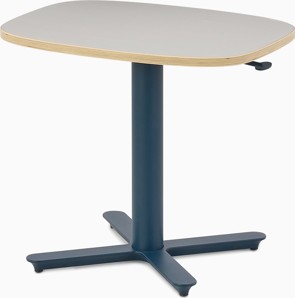 Small Passport Work Table with white surface, plywood edge and dark blue base shown on glides.