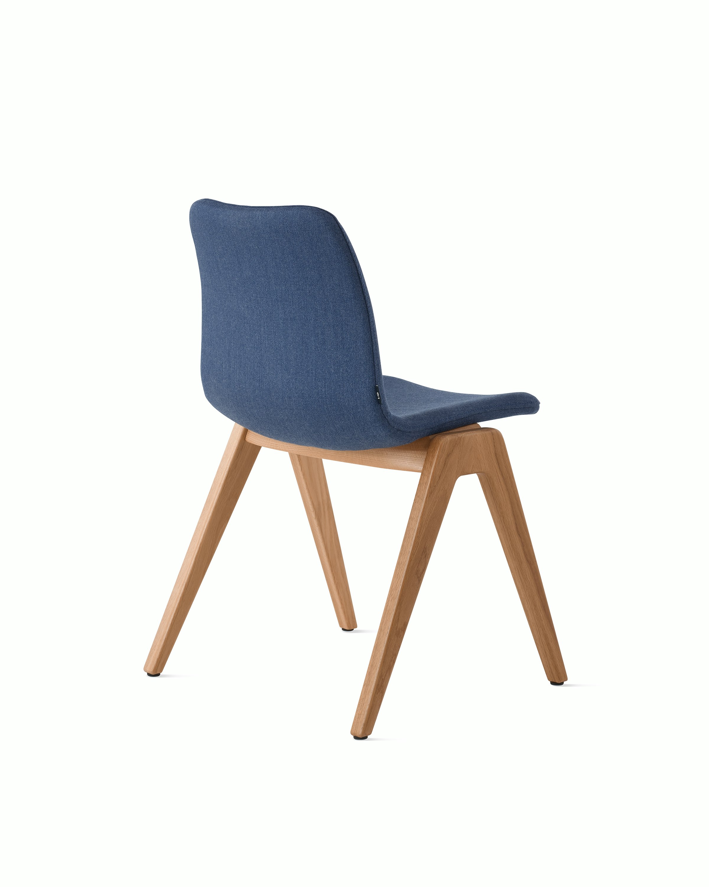 White sweep of Viv wood chair with dark blue fabric and 4 leg solid oak wood base