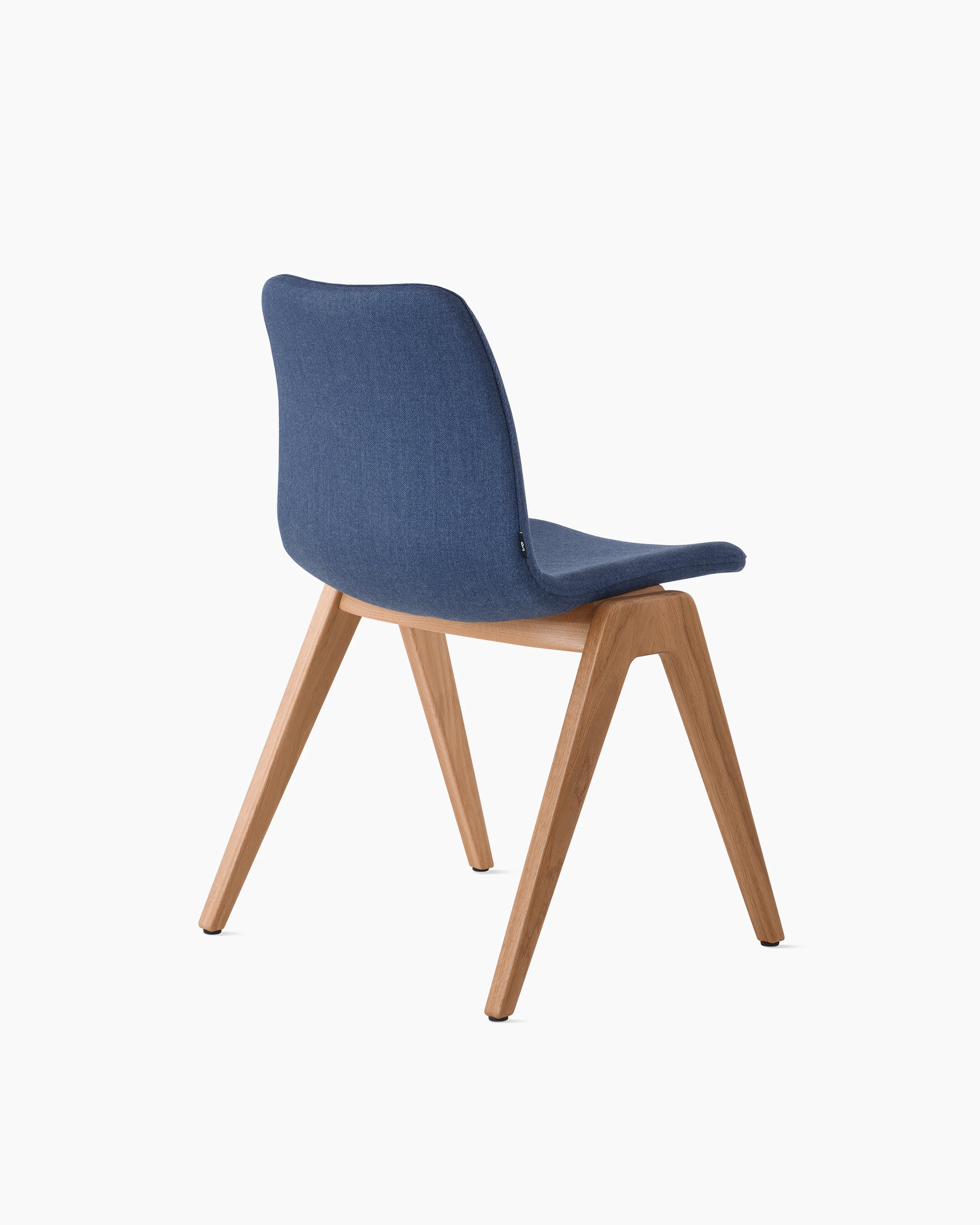 White sweep of Viv wood chair with dark blue fabric and 4 leg solid oak wood base