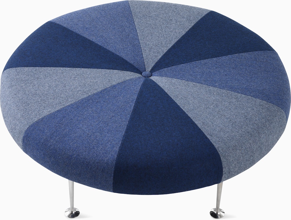 A Girard Color Wheel Ottoman upholstered in blue fabrics, viewed from the top. 