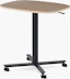 Large Passport Work Table with light woodgrain surface and black base on casters.