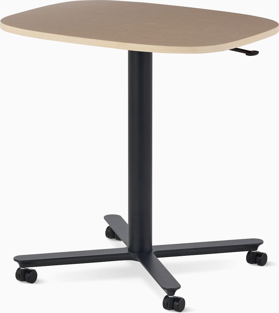 Large Passport Work Table with light woodgrain surface and black base on casters.