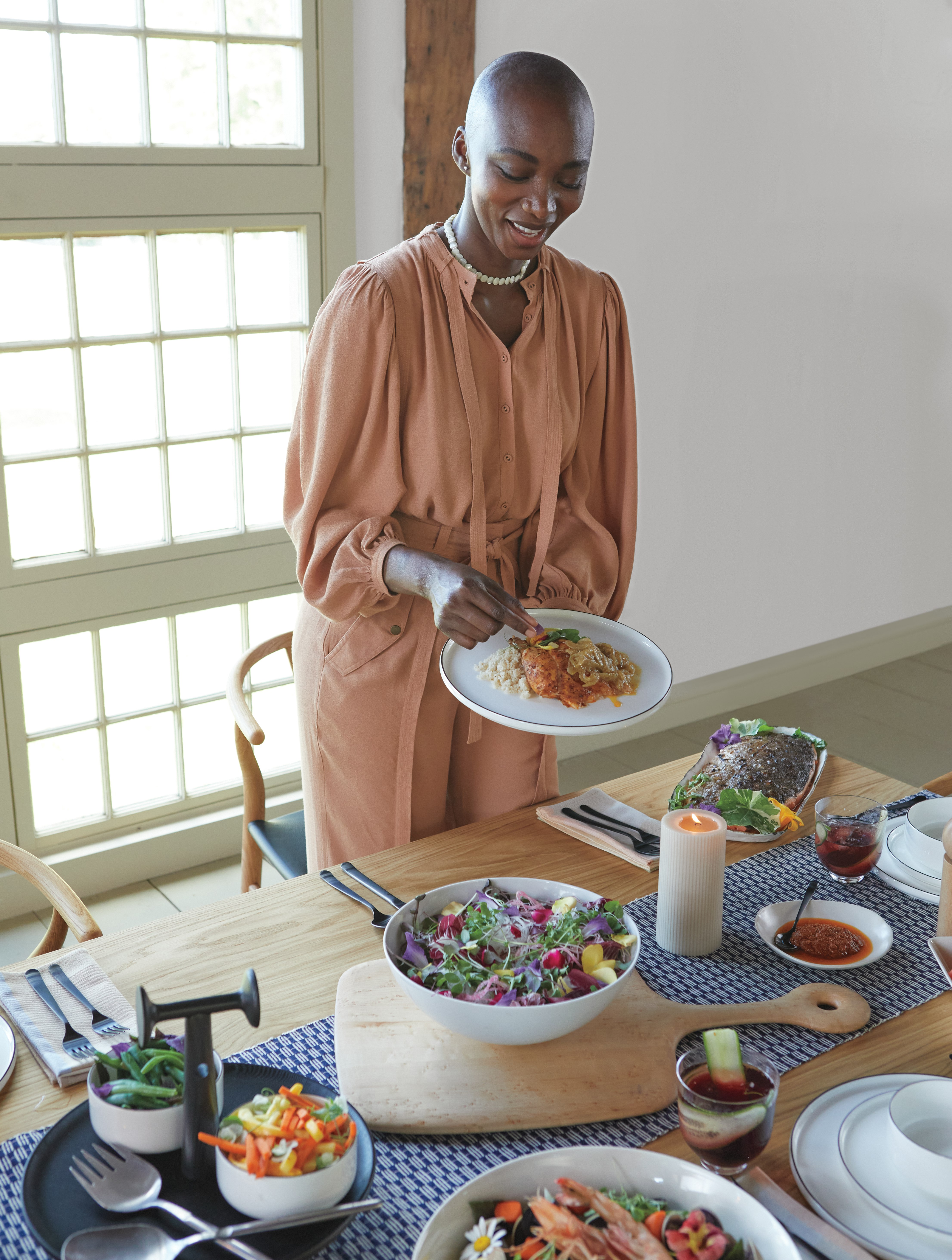 Chid Liberty and Georgie Badiel hosting dinner at Gather Table with Wishbone Chairs