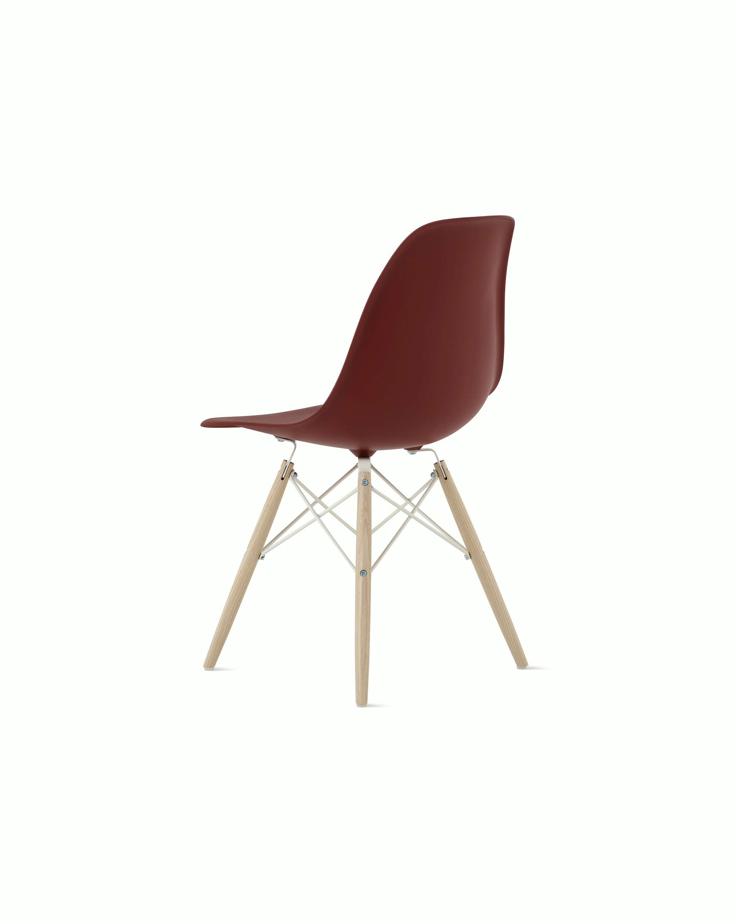 Back angle of brick red plastic shell chair with dowel base.