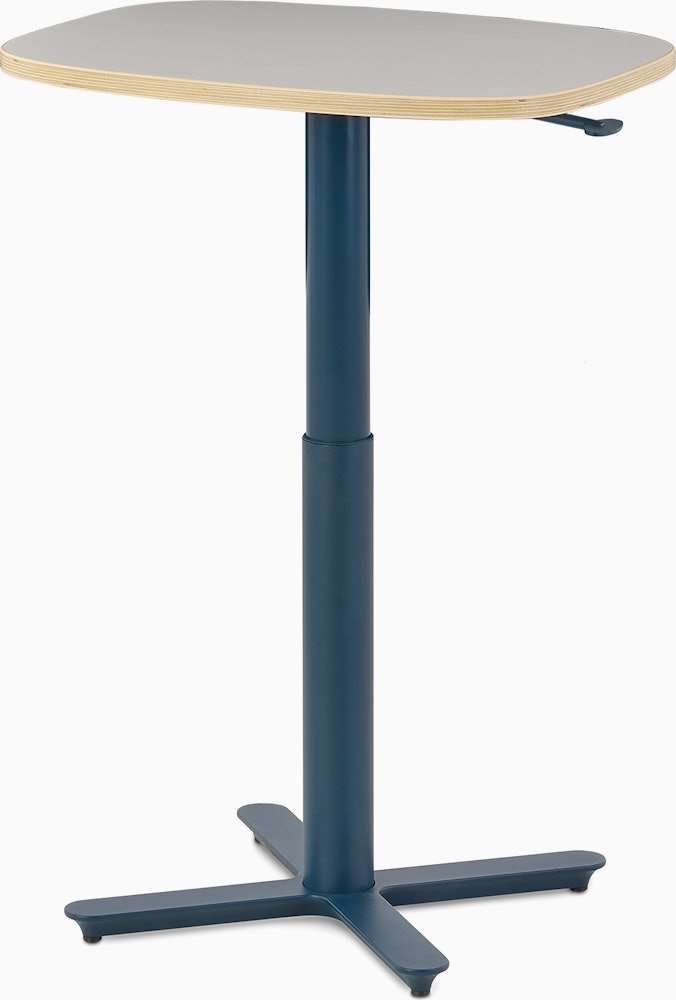 Small Passport Work Table with white surface, plywood edge and dark blue base shown on glides.