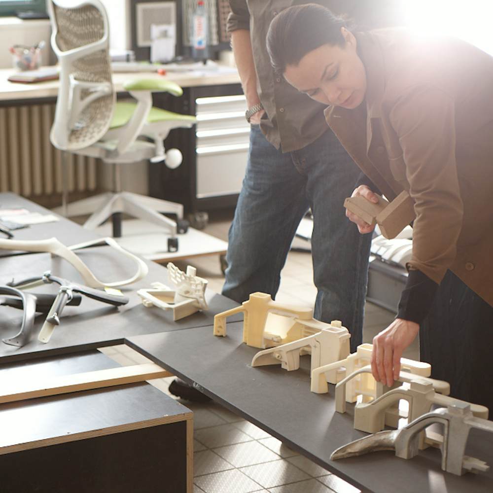 The Studio 7.5 design team looking at prototypes of components for one of the chairs they designed.