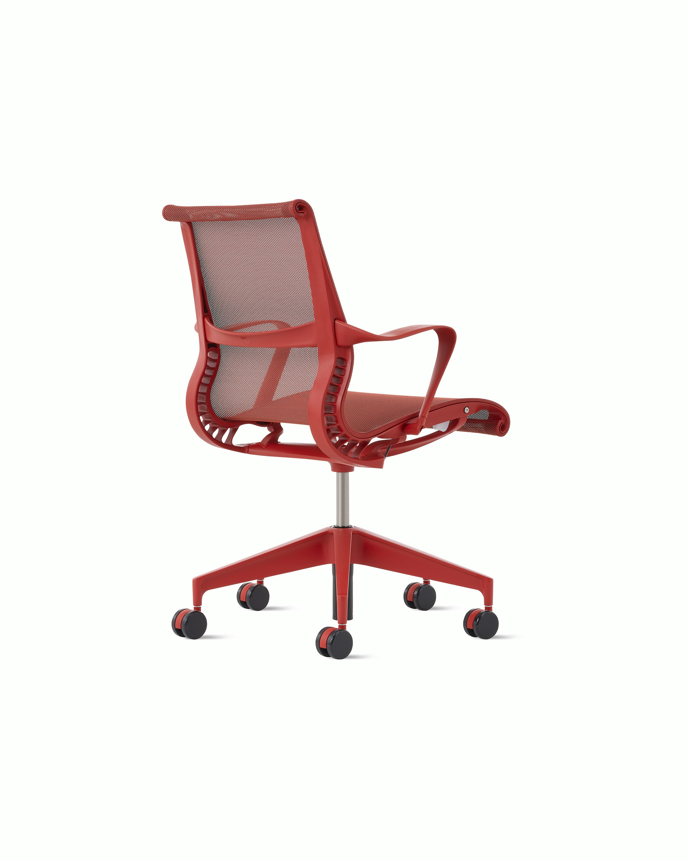 Rear angle view of a Setu chair with fixed arms in red.