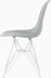 Side of light grey plastic shell chair on wire base.