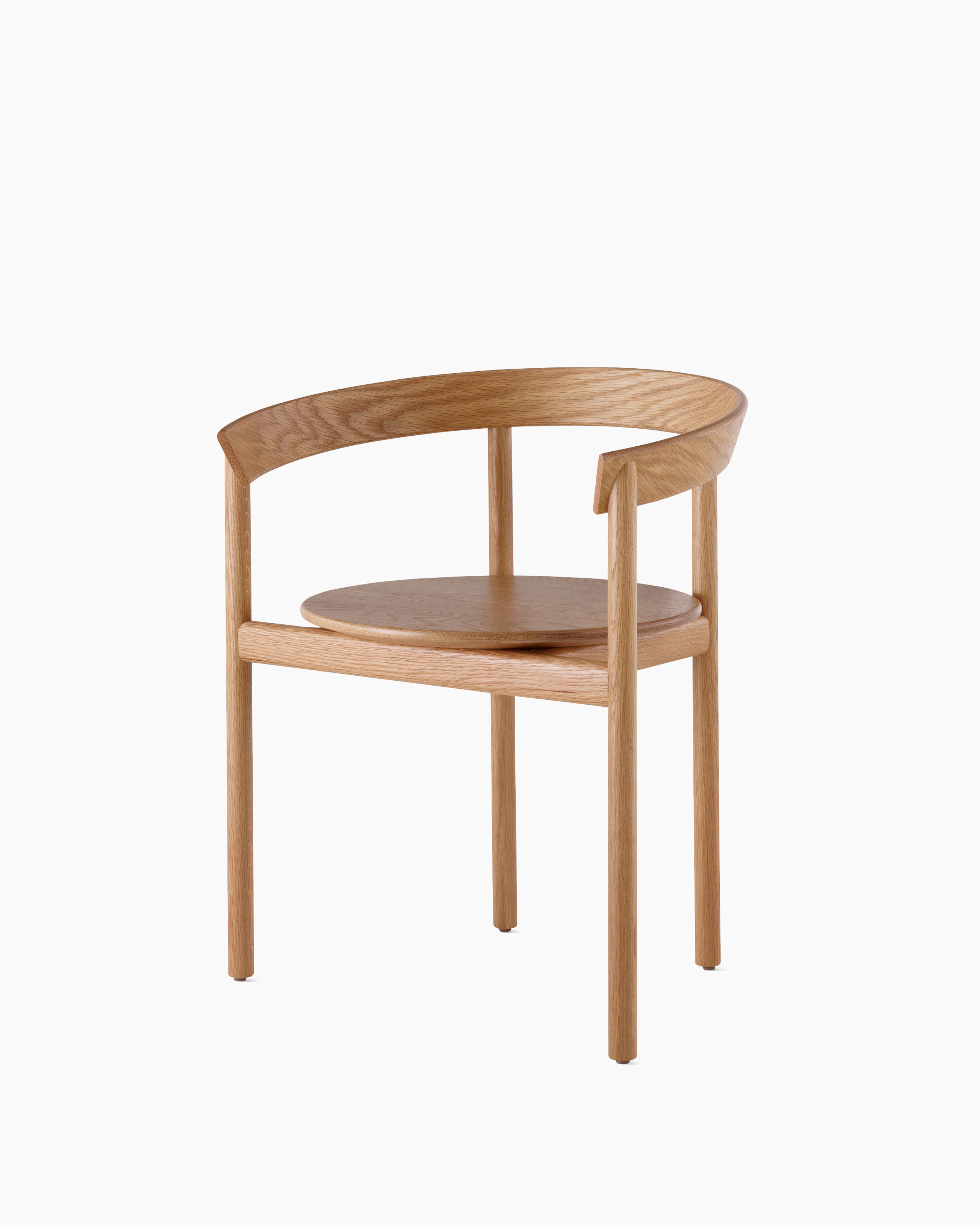 An oak Comma Chair with arms, viewed from the front at an angle.