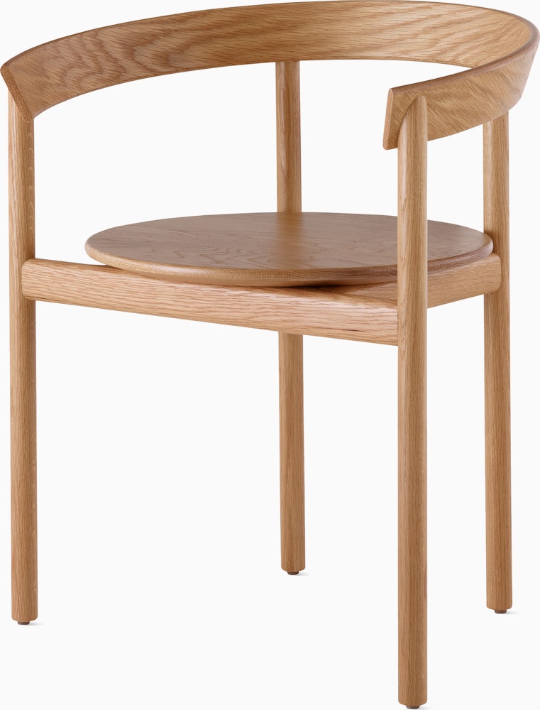 An oak Comma Chair with arms, viewed from the front at an angle.
