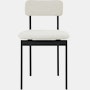 A Betwixt Chair with light grey fabric and a black frame.