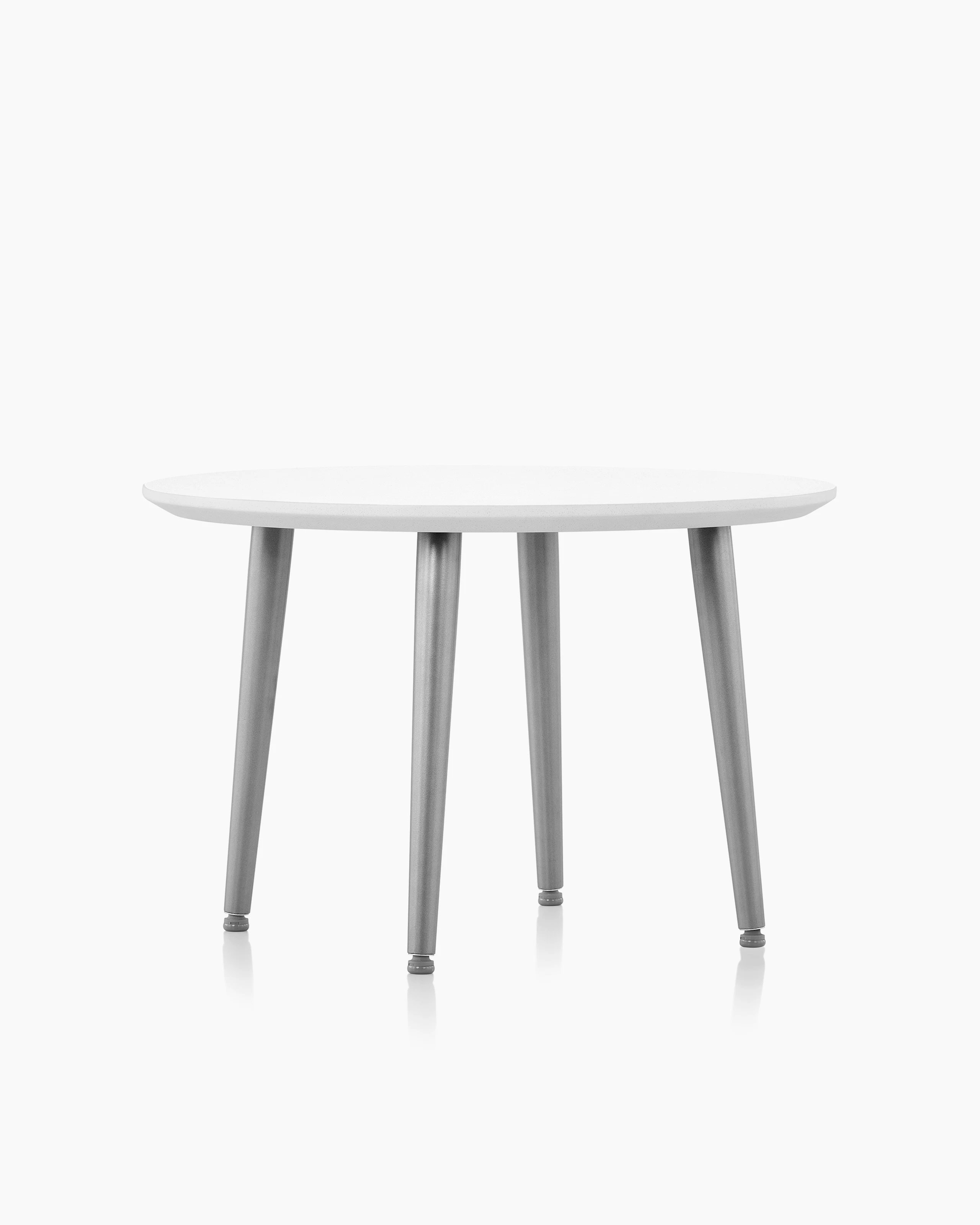 Palisade Occasional Table with metal legs and solid surface top on white sweep.