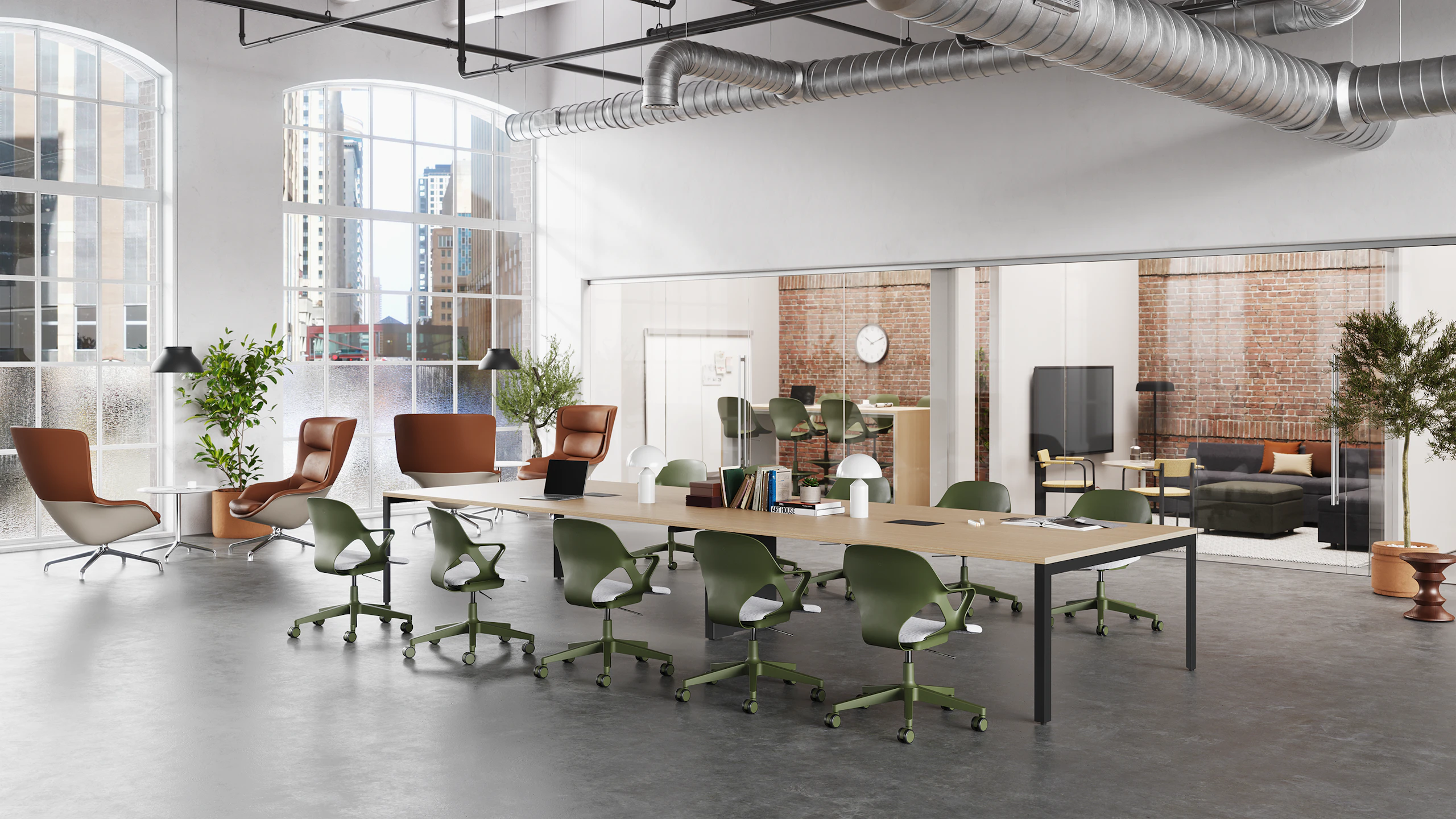 Twelve olive Zeph chairs with light grey seat pads surround a project table in the middle of a collaborative space with two adjacent rooms.
