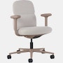 Front angle view of a mid-back Asari chair by Herman Miller in light brown with height adjustable arms.