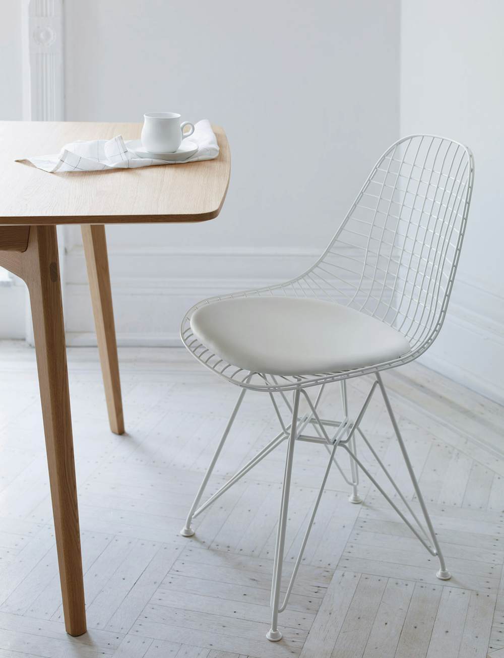 Eames Wire Side Chair with Seat Pad at a dining table